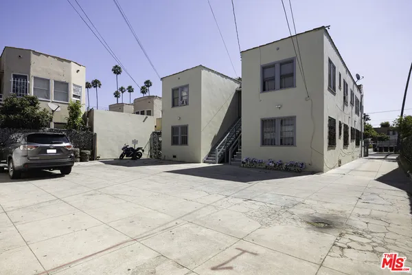 a view of a parking space in front of a house