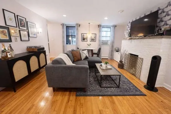 a living room with fireplace furniture and a flat screen tv