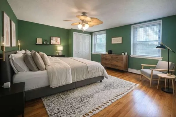 a bedroom with a bed and a mirror on dresser