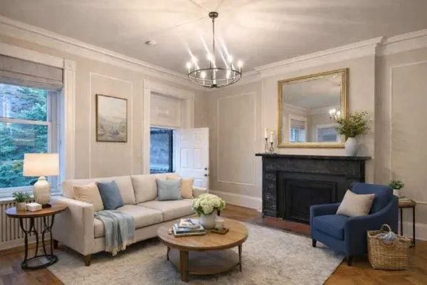 a living room with furniture a fireplace and a chandelier