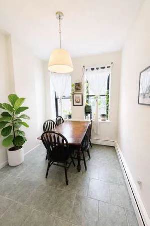 a dining room with furniture and window
