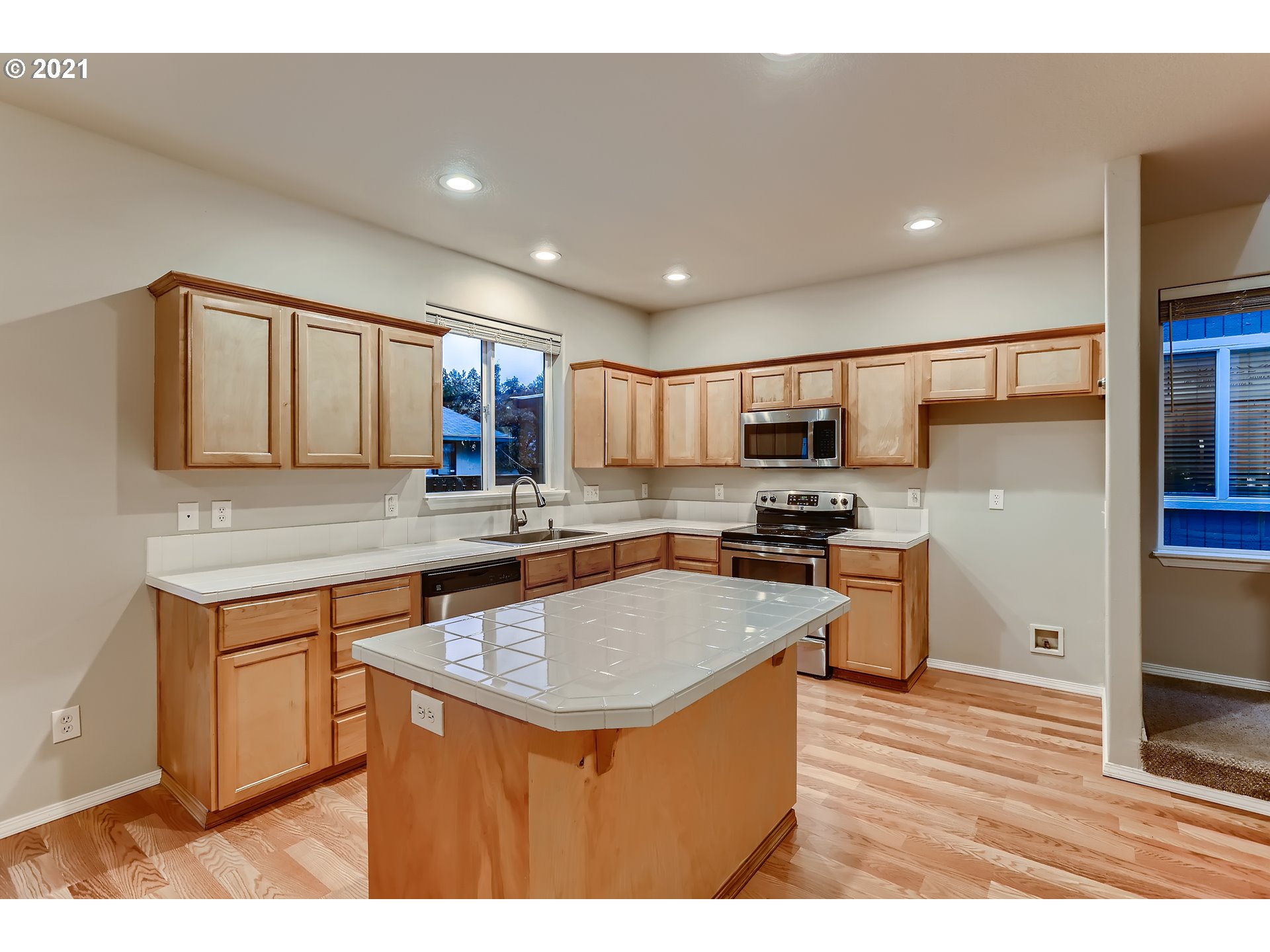 17670 Southwest September Lane Beaverton, OR 97003 - Photo 11 of 31 a kitchen with stainless steel appliances granite countertop a sink stove and refrigerator