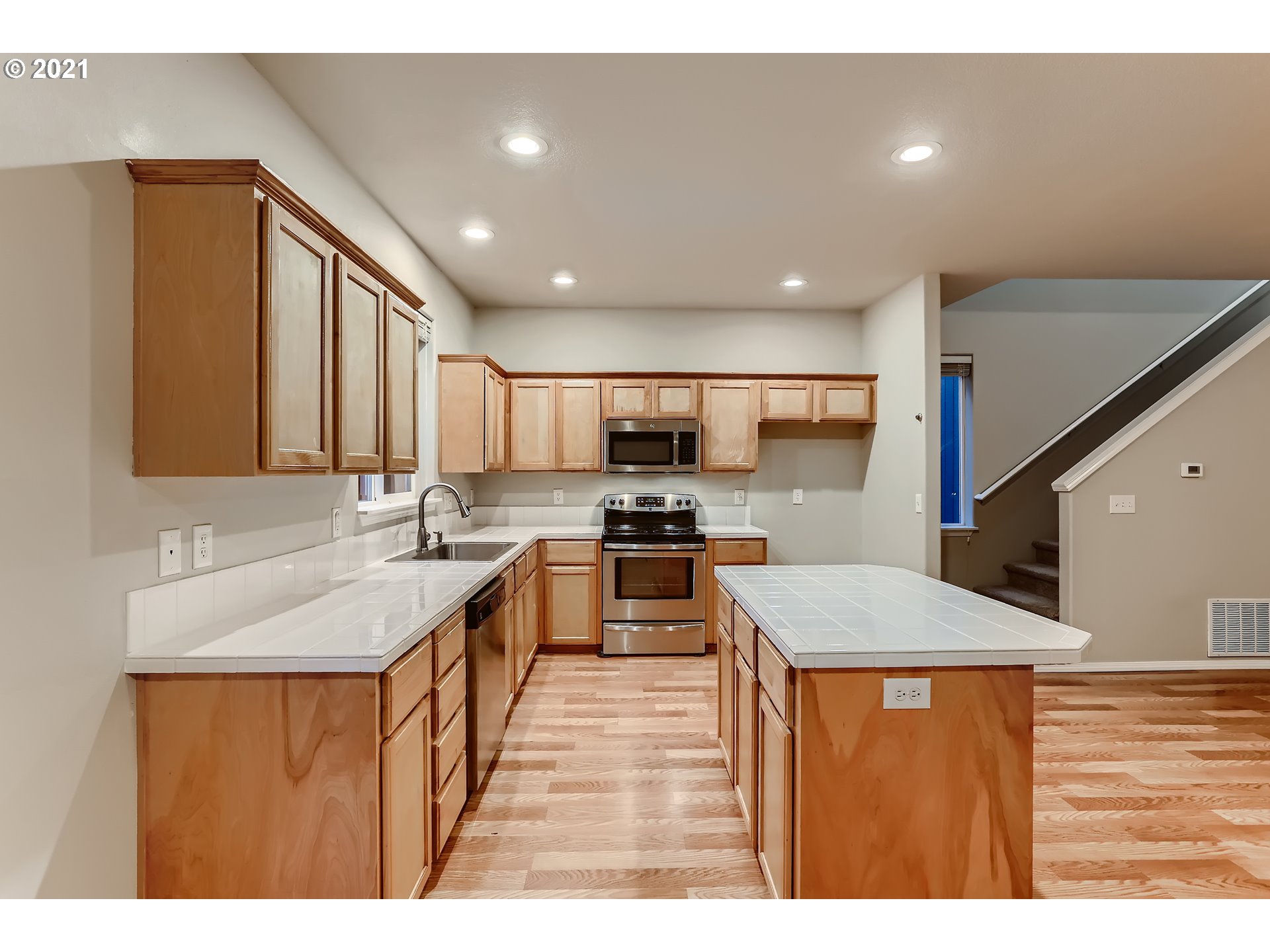 17670 Southwest September Lane Beaverton, OR 97003 - Photo 12 of 31 a kitchen with stainless steel appliances granite countertop a sink stove and refrigerator
