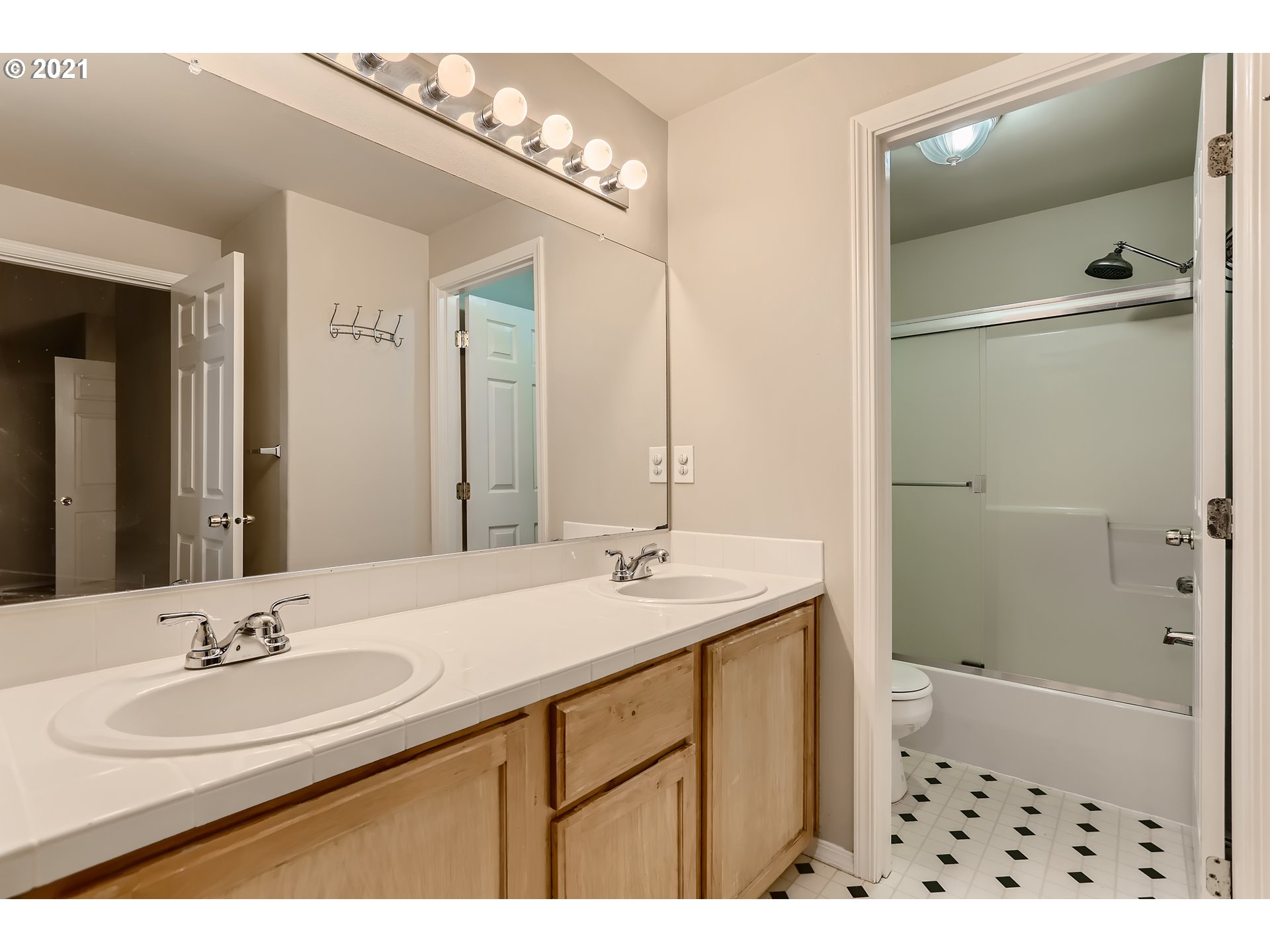 17670 Southwest September Lane Beaverton, OR 97003 - Photo 19 of 31 a bathroom with a sink a shower a mirror and a bathtub