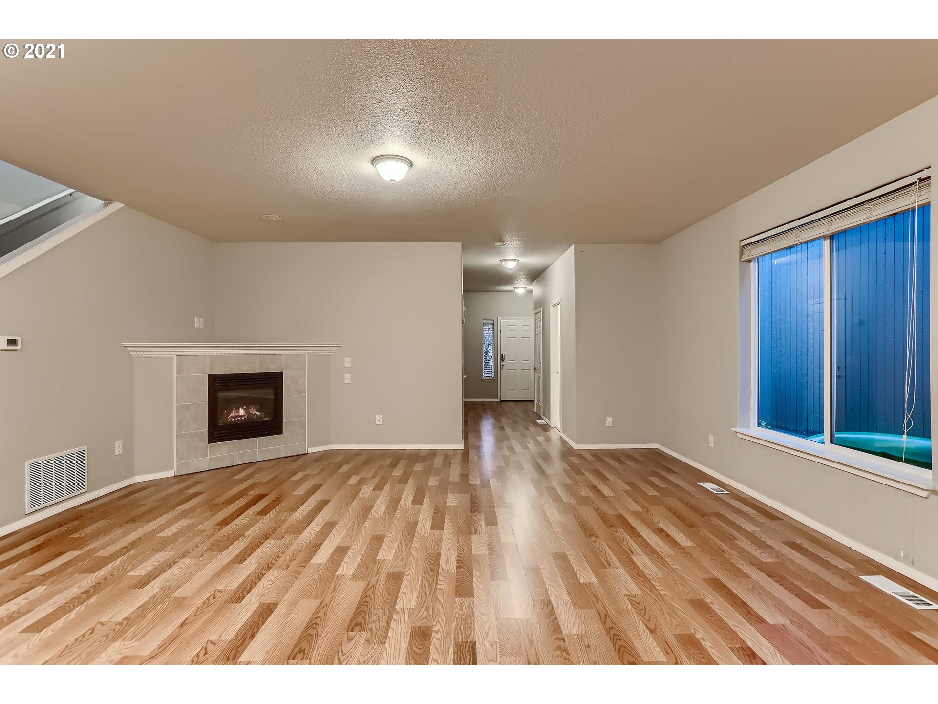 17670 Southwest September Lane Beaverton, OR 97003 - Photo 9 of 31 a view of an empty room with window and wooden floor