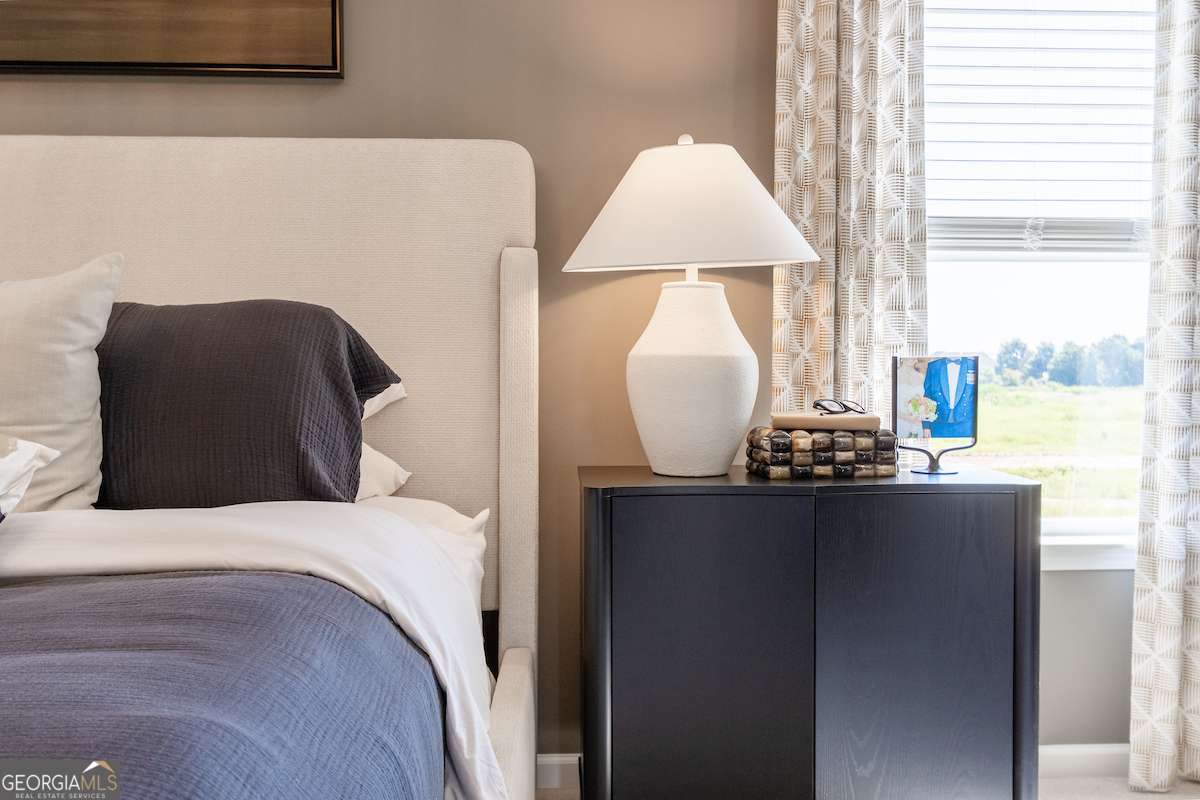 1422 Trellis Court, Unit (LOT 22) Hampton, GA 30228 - Photo 29 of 34 a bedroom with a bed and dresser