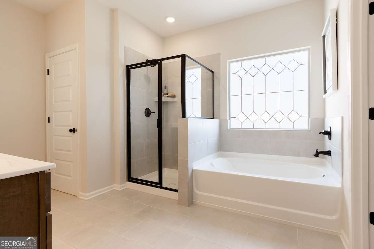 1422 Trellis Court, Unit (LOT 22) Hampton, GA 30228 - Photo 33 of 34 a spacious bathroom with a bathtub and a shower