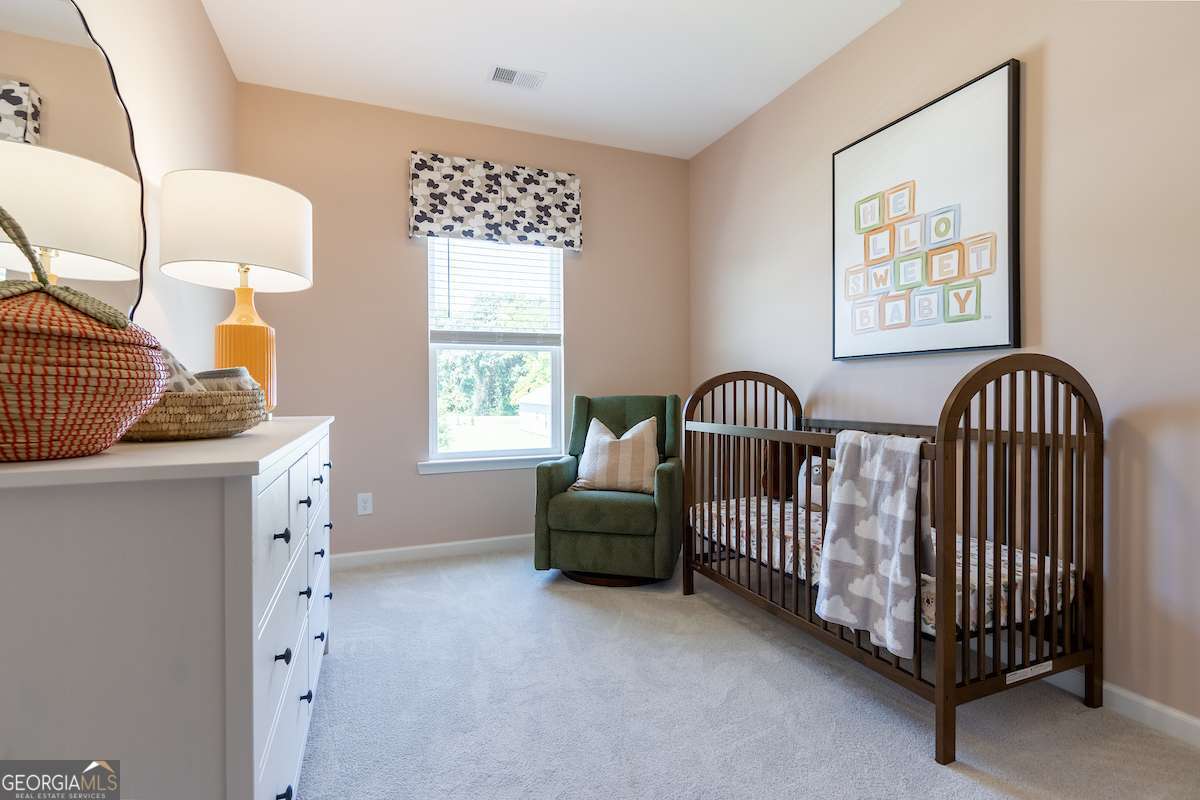 1422 Trellis Court, Unit (LOT 22) Hampton, GA 30228 - Photo 5 of 34 a bedroom with a bed and a chair