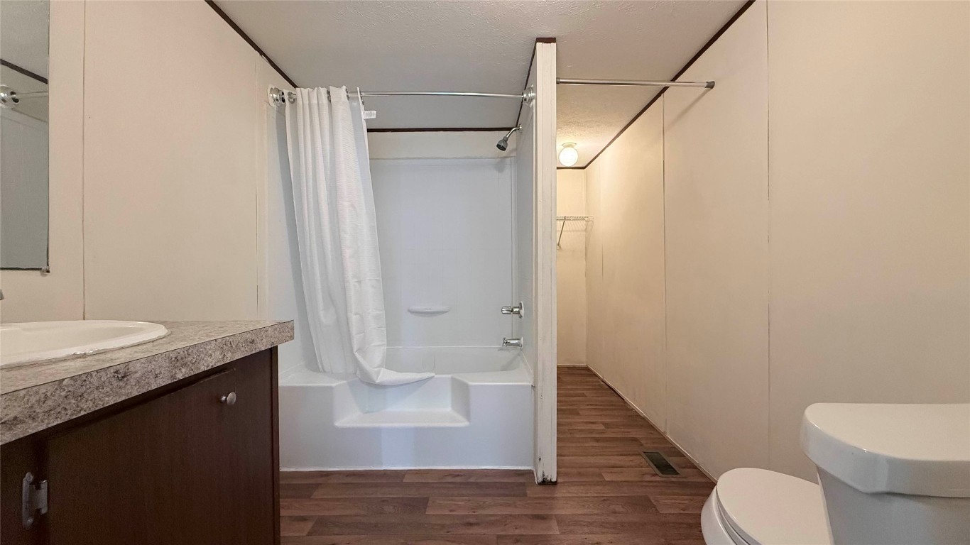 1430 West Howard Lane, Unit 4 Austin, TX 78728 - Photo 16 of 18 a bathroom with a granite countertop sink toilet and shower