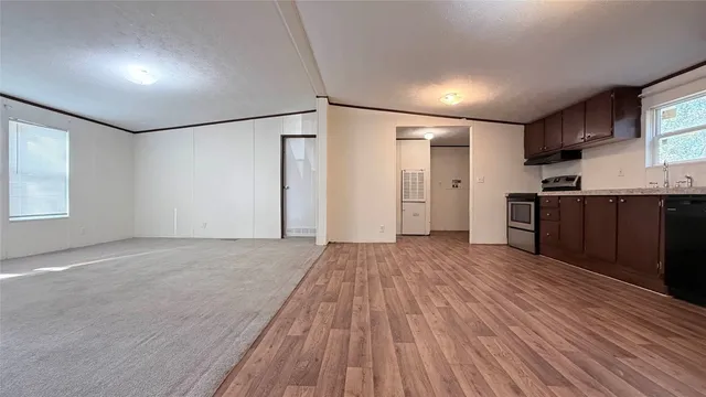 a view of empty room with wooden floor