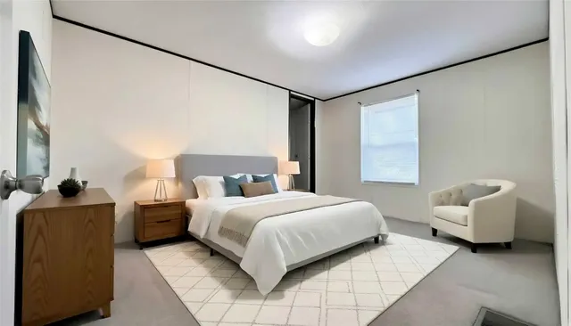 a bedroom with a bed and a couch