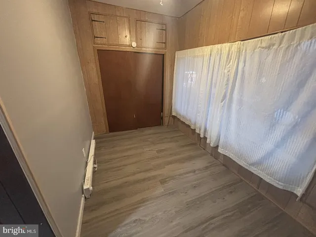 a view of a room with wooden walls