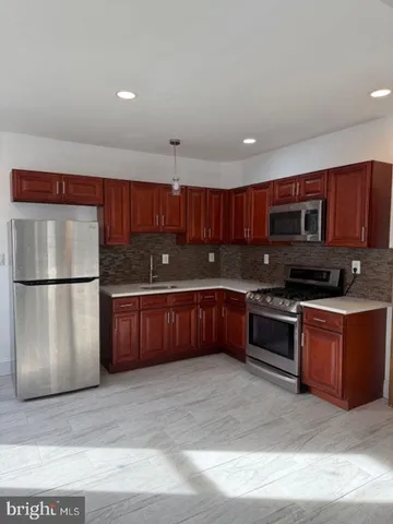a kitchen with stainless steel appliances granite countertop a refrigerator stove a sink and dishwasher