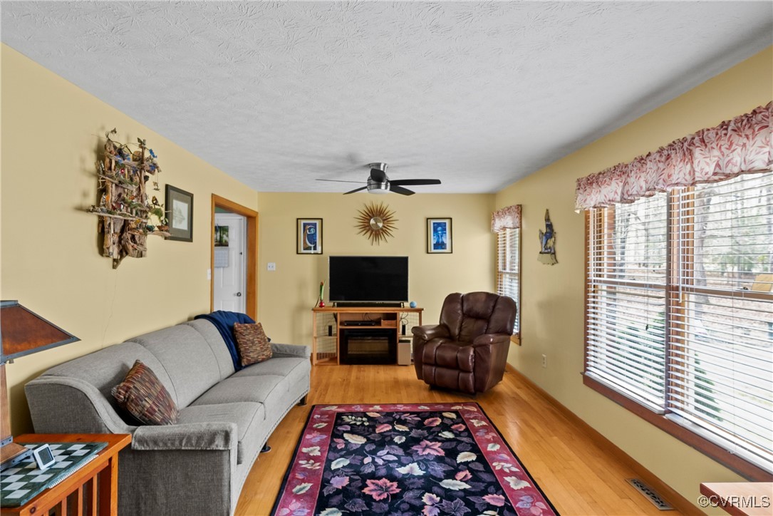 9320 Old Forge Road Providence Forge, VA 23140 - Photo 5 of 50 Living room featuring a textured ceiling, visible