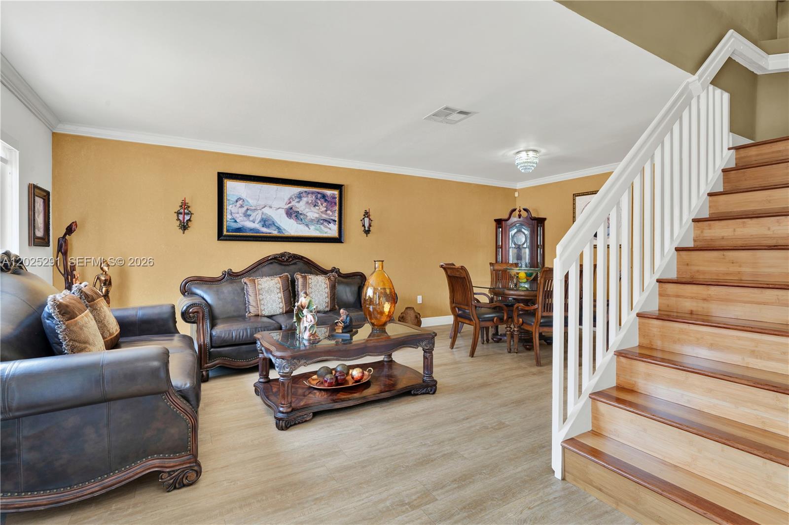 10006 Southwest 162nd Path Miami, FL 33196 - Photo 8 of 40 a living room with furniture and a dining table with wooden floor