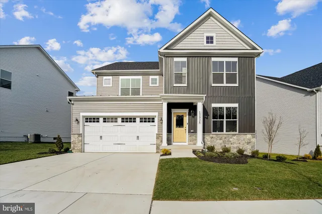 a view of a white house next to a yard