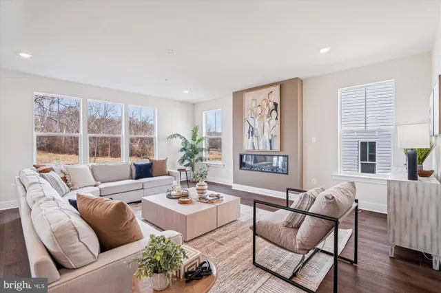 a living room with furniture and window with wooden floor