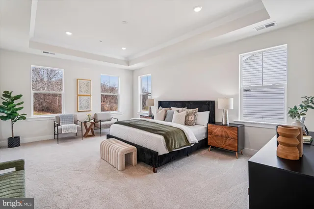 a spacious bedroom with a bed and furniture