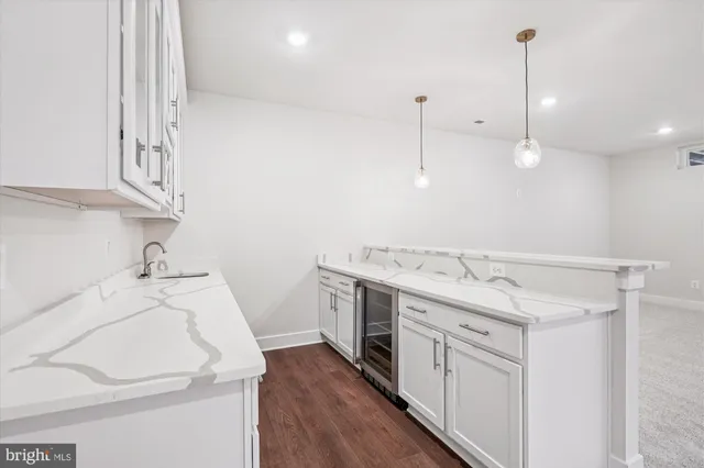 a utility room with sink dryer and washer