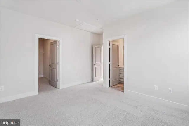 an empty room with closet and a window