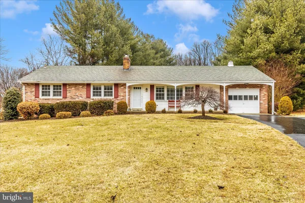 a view of a white house with a swimming pool