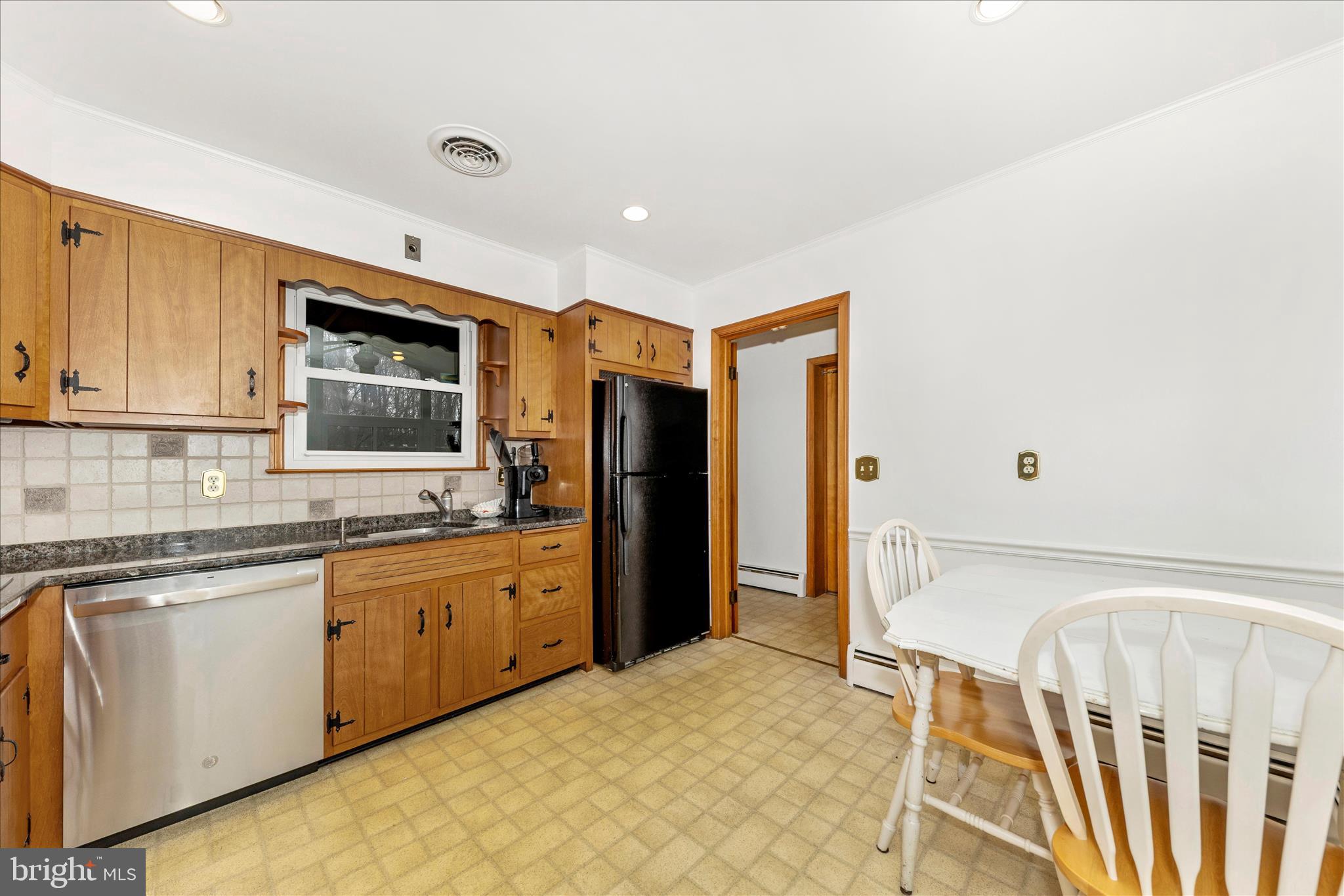 9811 Watkins Road Gaithersburg, MD 20882 - Photo 11 of 54 a kitchen with granite countertop a sink stove refrigerator and cabinets