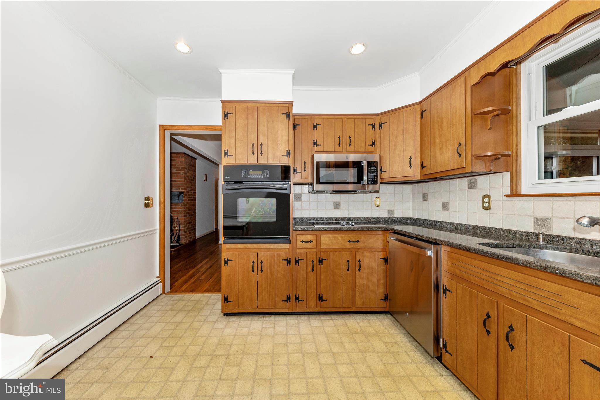 9811 Watkins Road Gaithersburg, MD 20882 - Photo 13 of 54 a large kitchen with stainless steel appliances granite countertop a stove a sink and a refrigerator