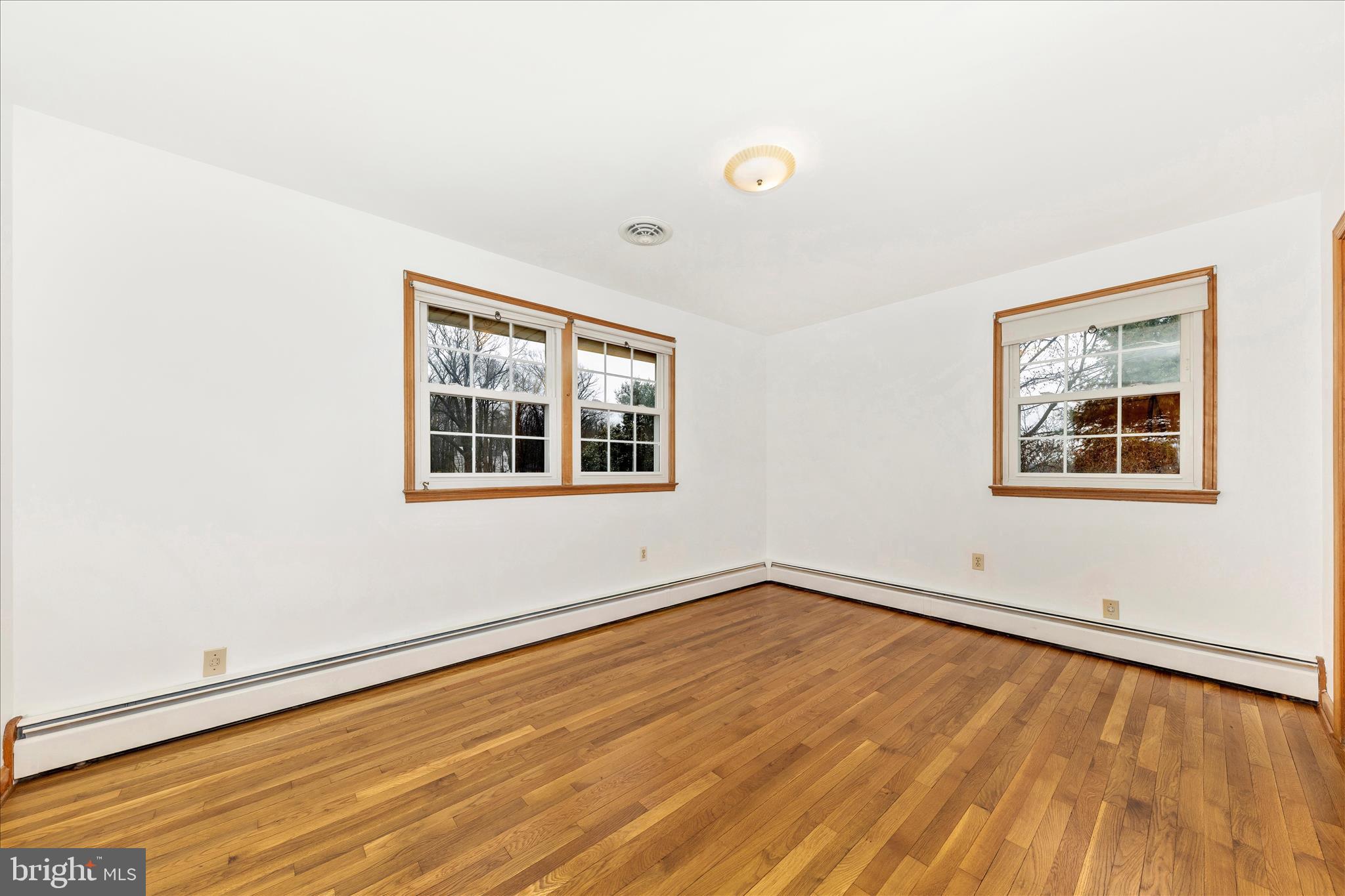 9811 Watkins Road Gaithersburg, MD 20882 - Photo 14 of 54 a view of empty room with wooden floor and fan