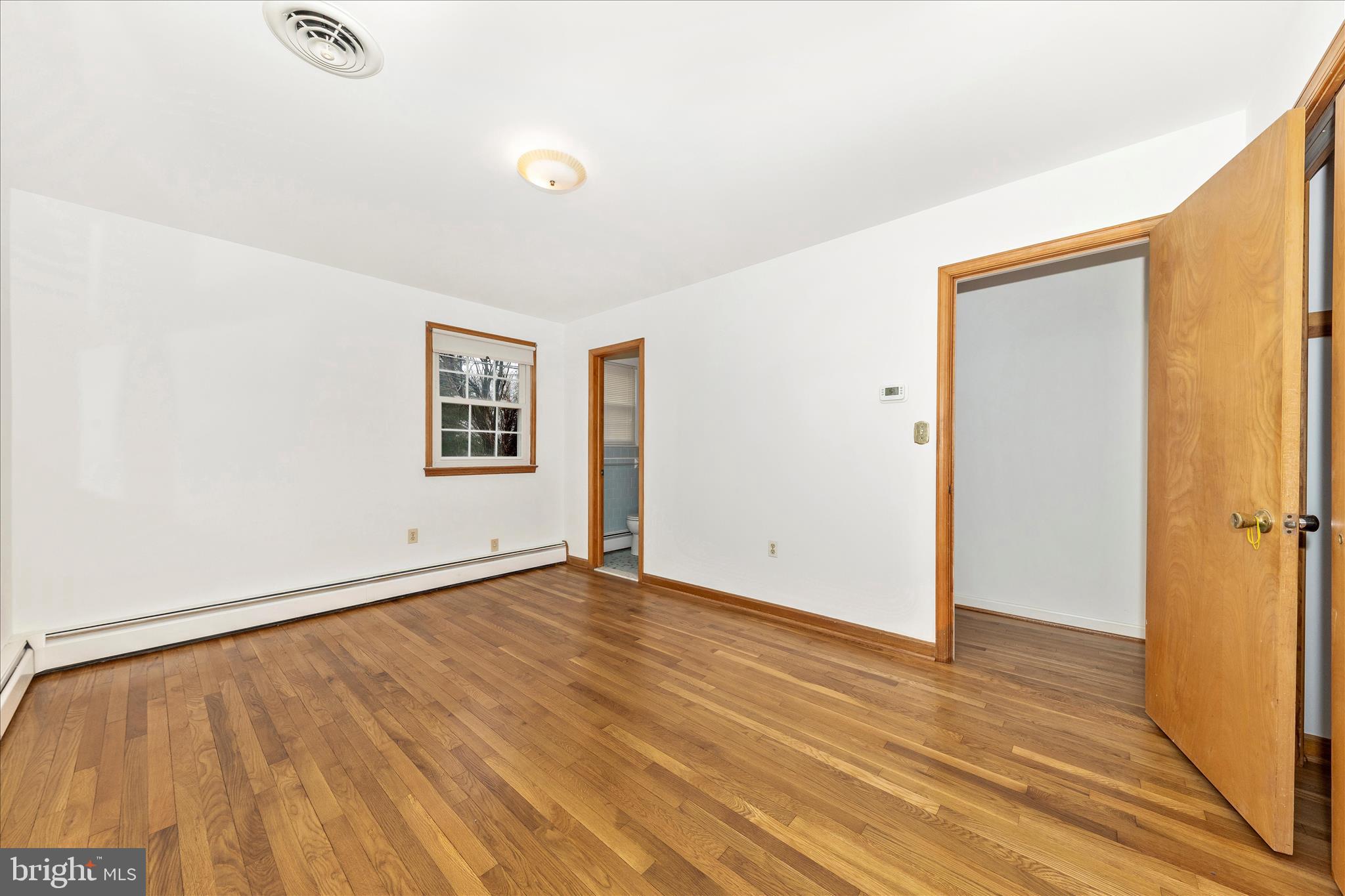 9811 Watkins Road Gaithersburg, MD 20882 - Photo 15 of 54 an empty room with wooden floor and windows