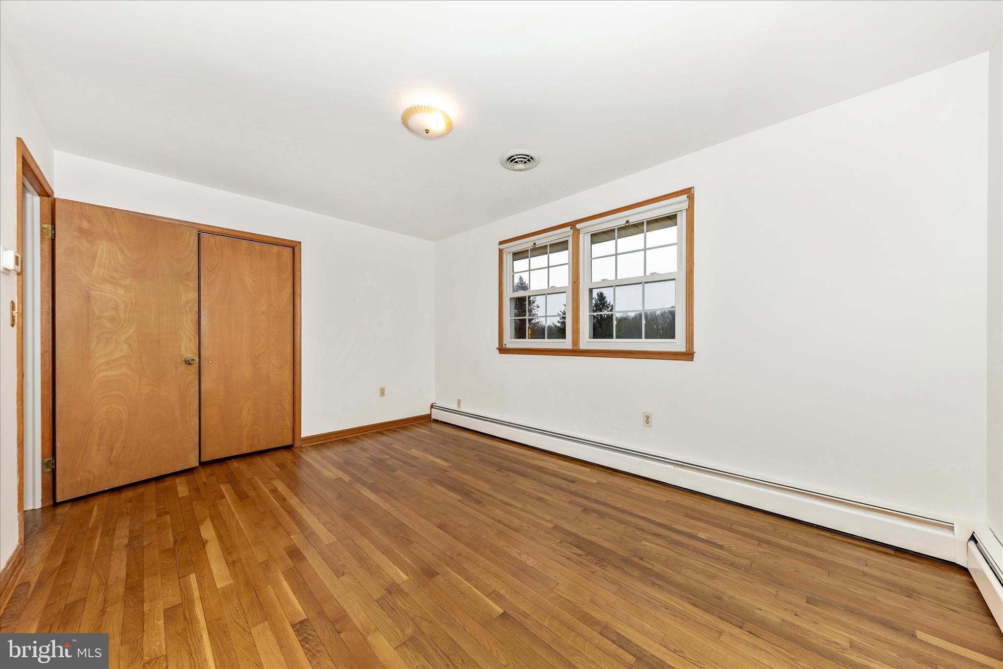 9811 Watkins Road Gaithersburg, MD 20882 - Photo 17 of 54 an empty room with wooden floor and windows