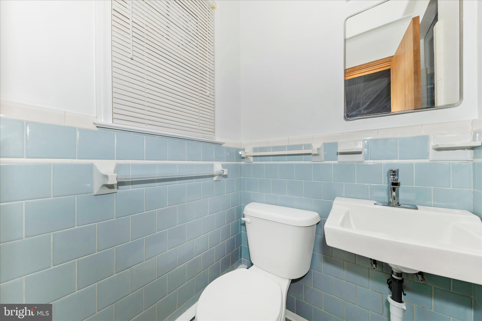 9811 Watkins Road Gaithersburg, MD 20882 - Photo 18 of 54 a bathroom with a sink a toilet and a mirror