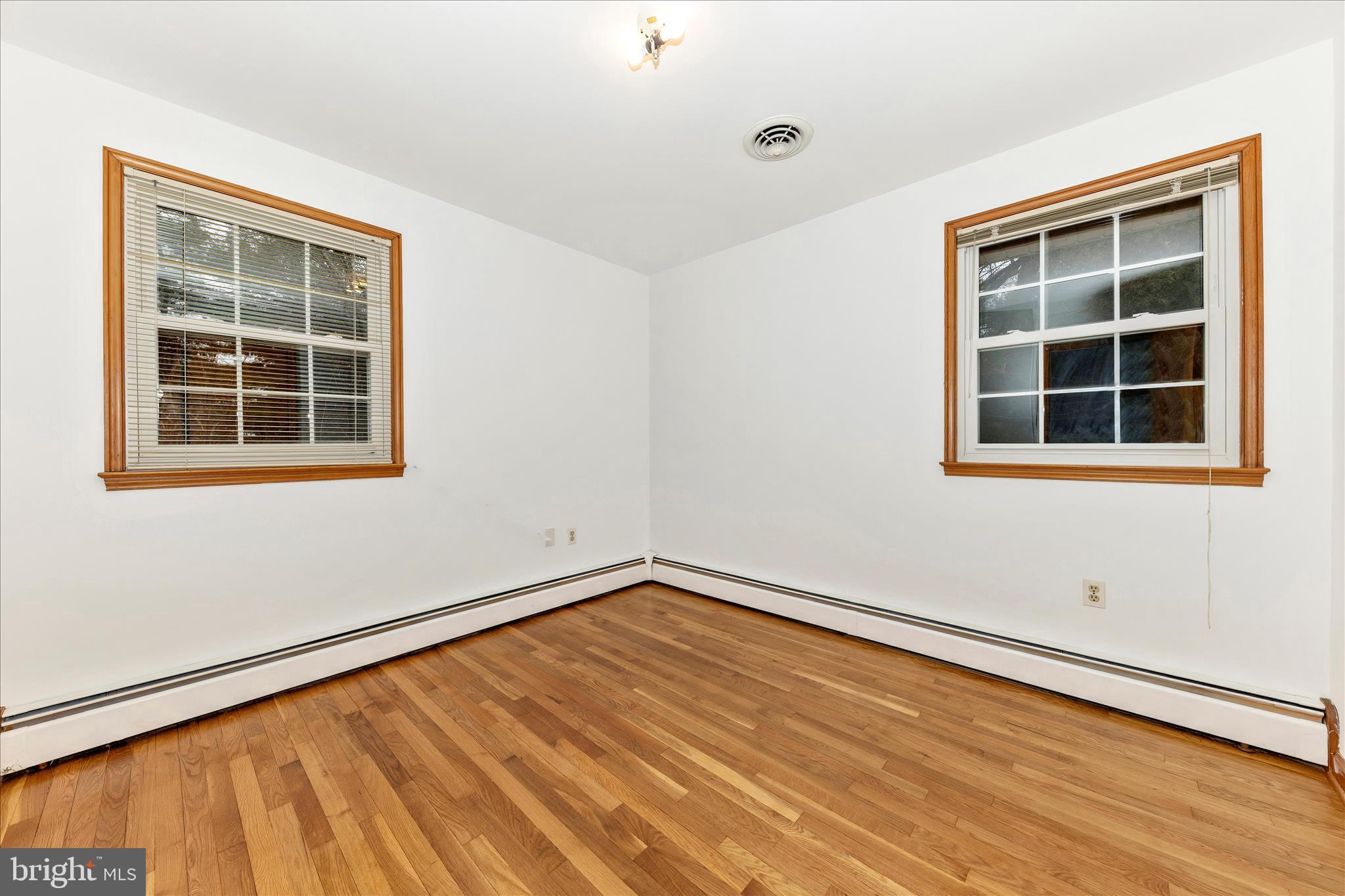9811 Watkins Road Gaithersburg, MD 20882 - Photo 20 of 54 an empty room with wooden floor and windows
