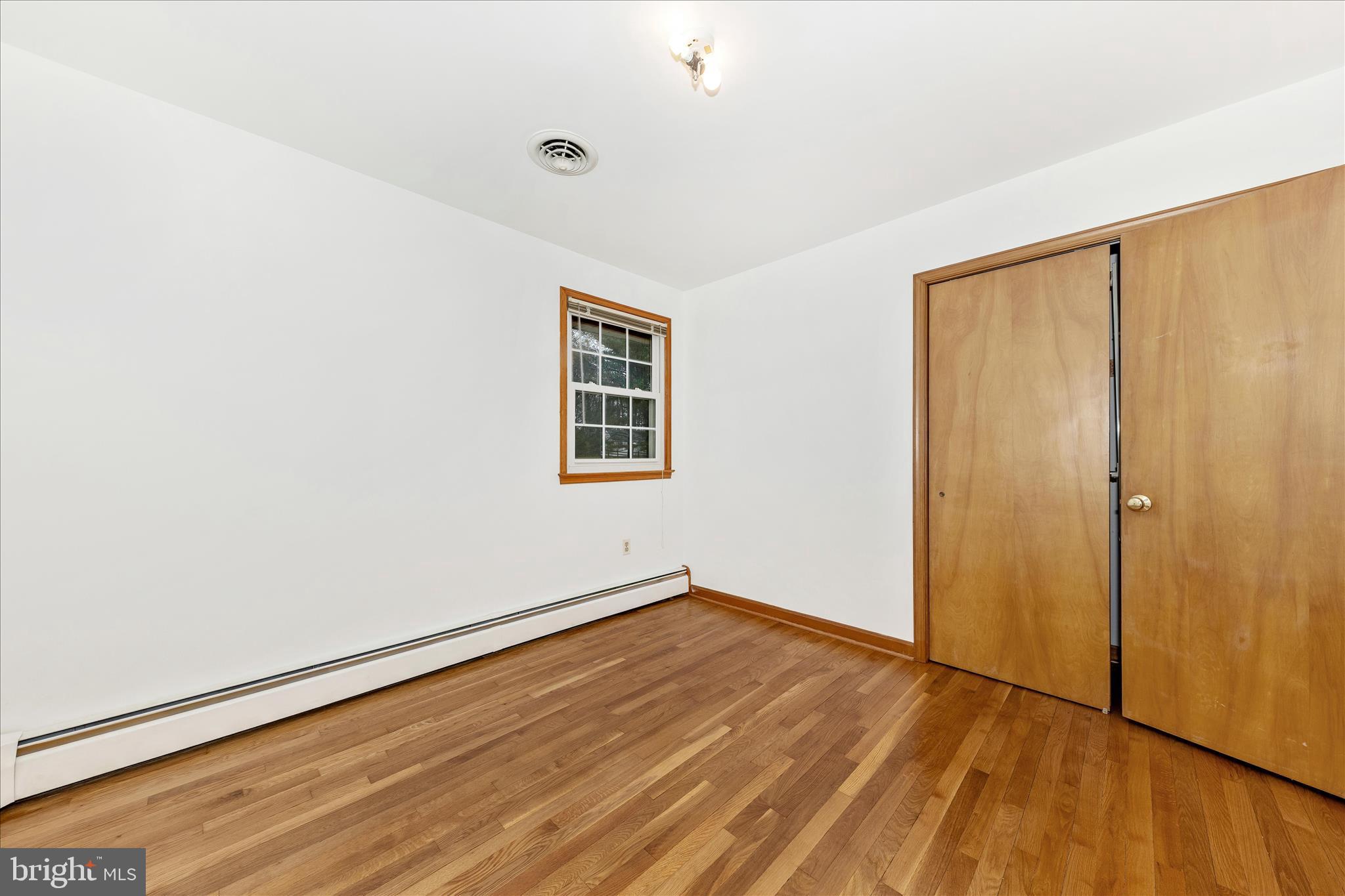 9811 Watkins Road Gaithersburg, MD 20882 - Photo 21 of 54 an empty room with wooden floor and windows