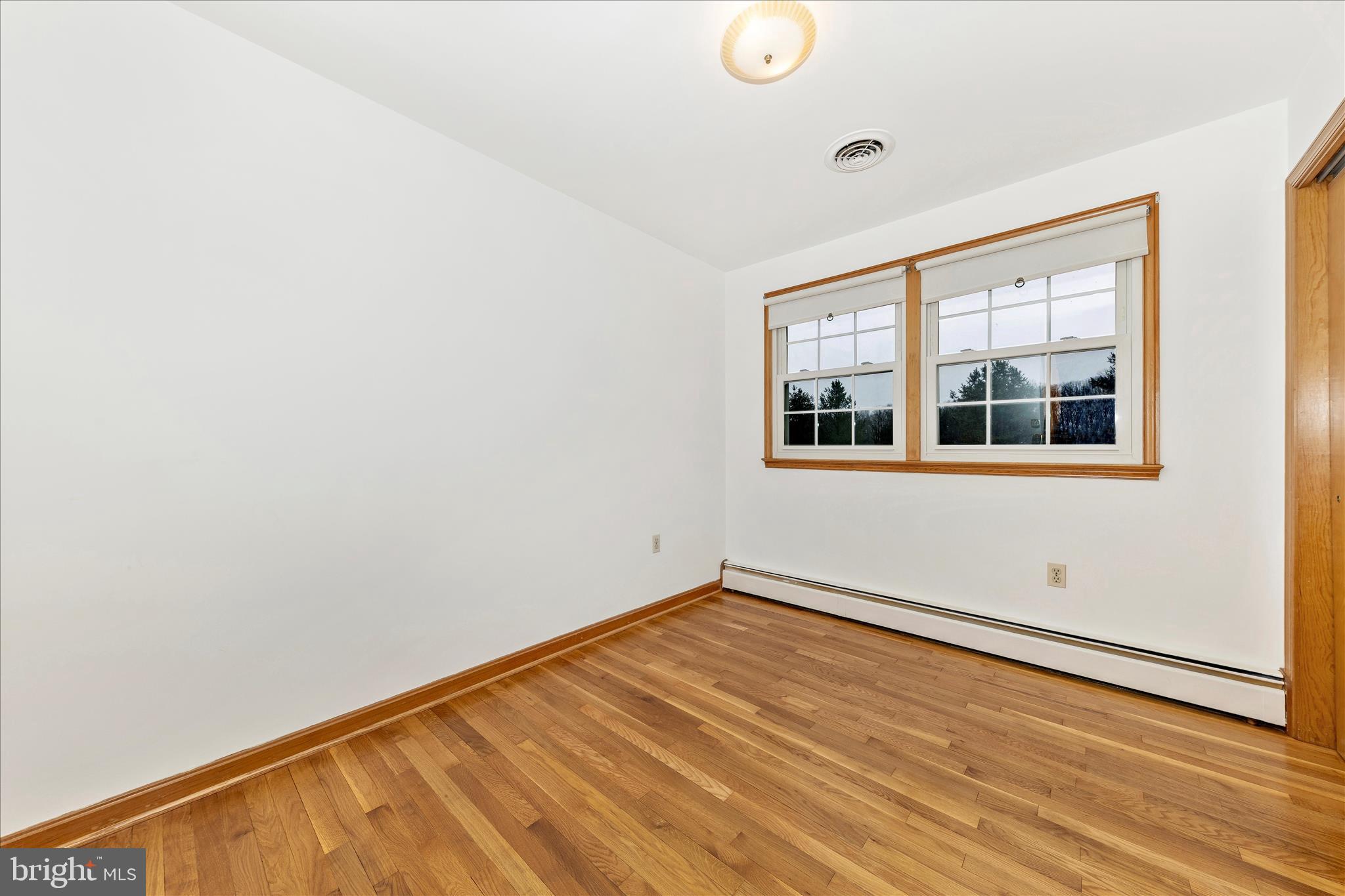 9811 Watkins Road Gaithersburg, MD 20882 - Photo 22 of 54 a view of empty room with wooden floor and fan