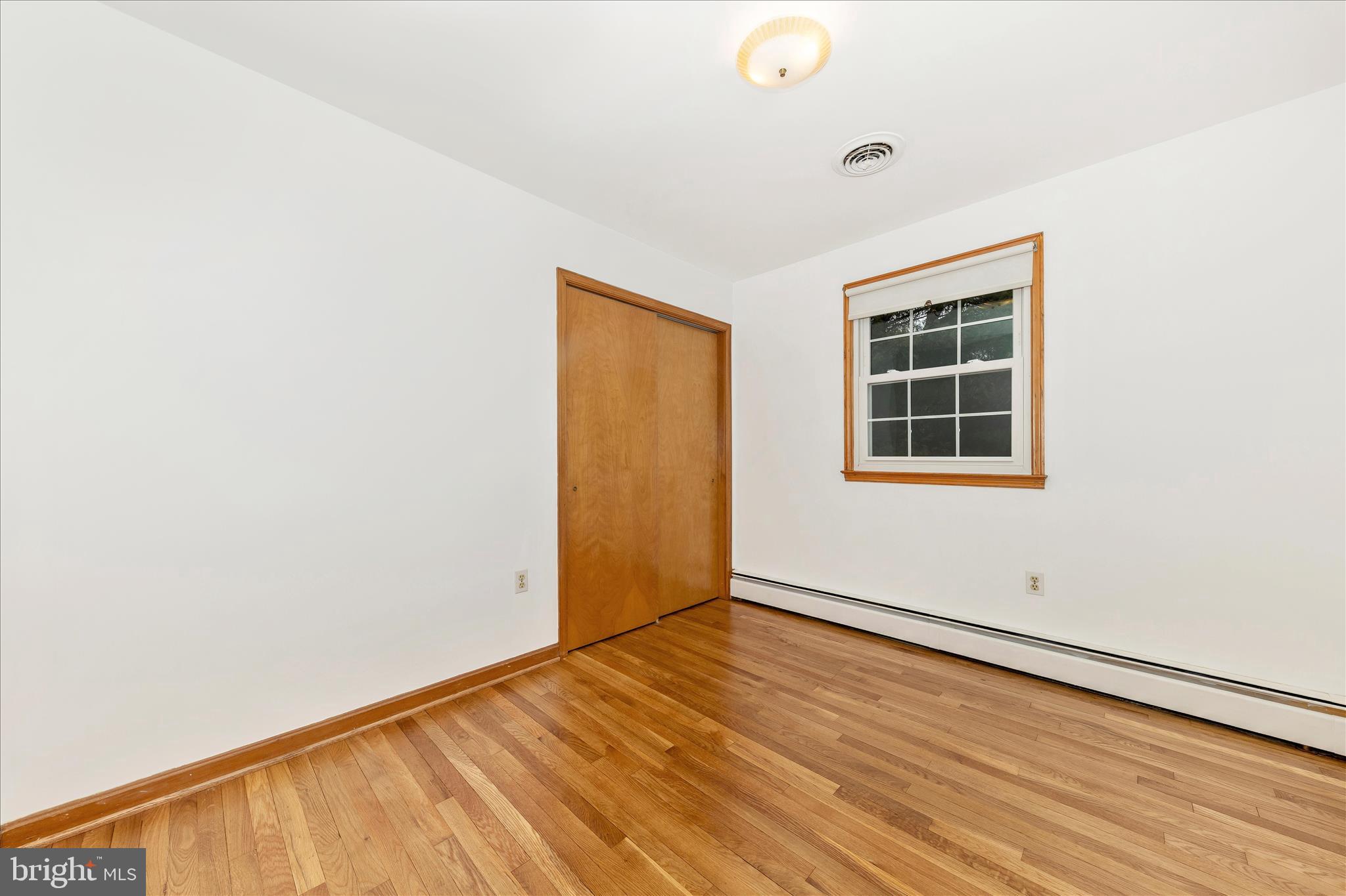9811 Watkins Road Gaithersburg, MD 20882 - Photo 24 of 54 an empty room with wooden floor and windows