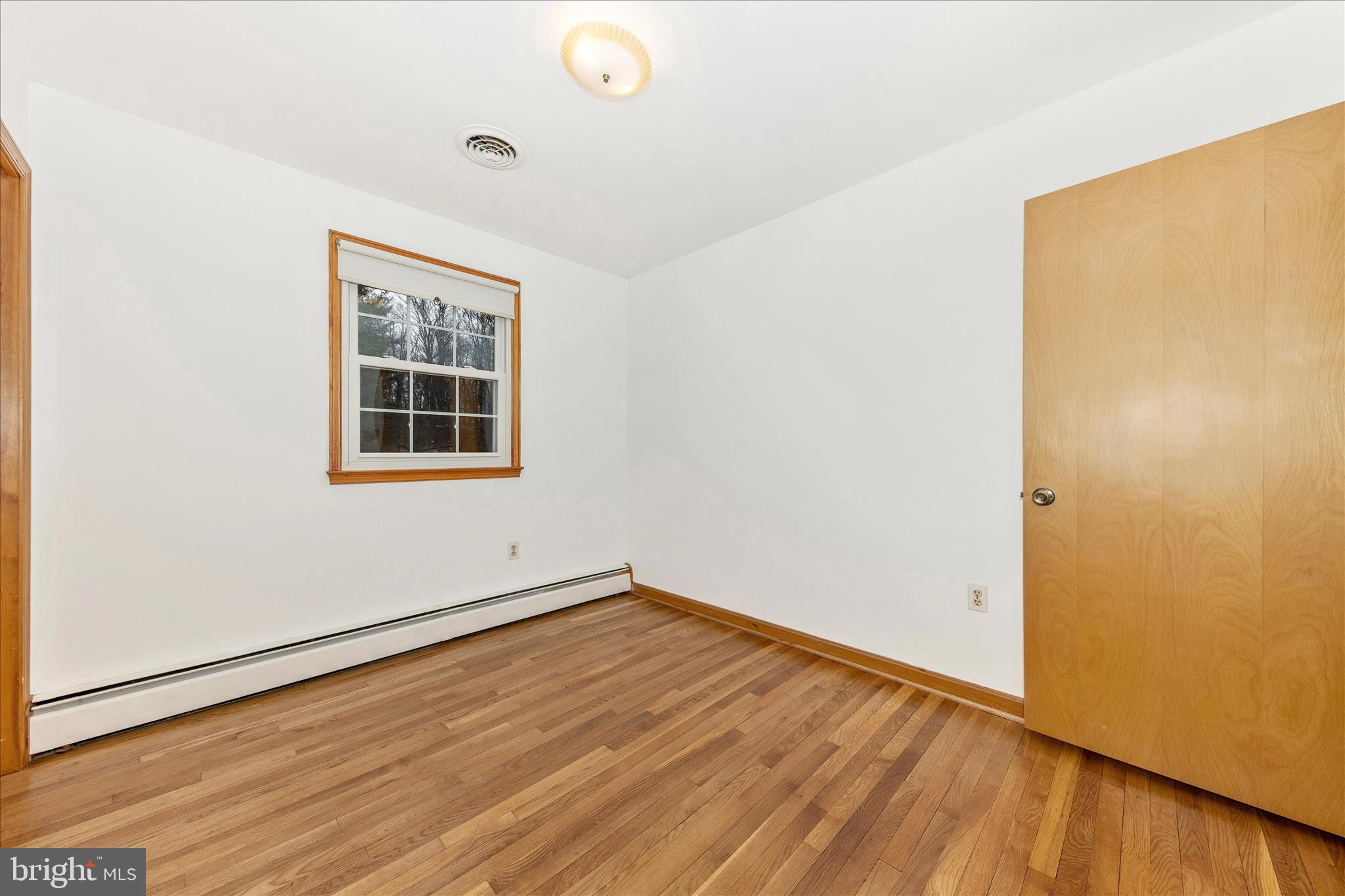 9811 Watkins Road Gaithersburg, MD 20882 - Photo 25 of 54 an empty room with wooden floor and windows