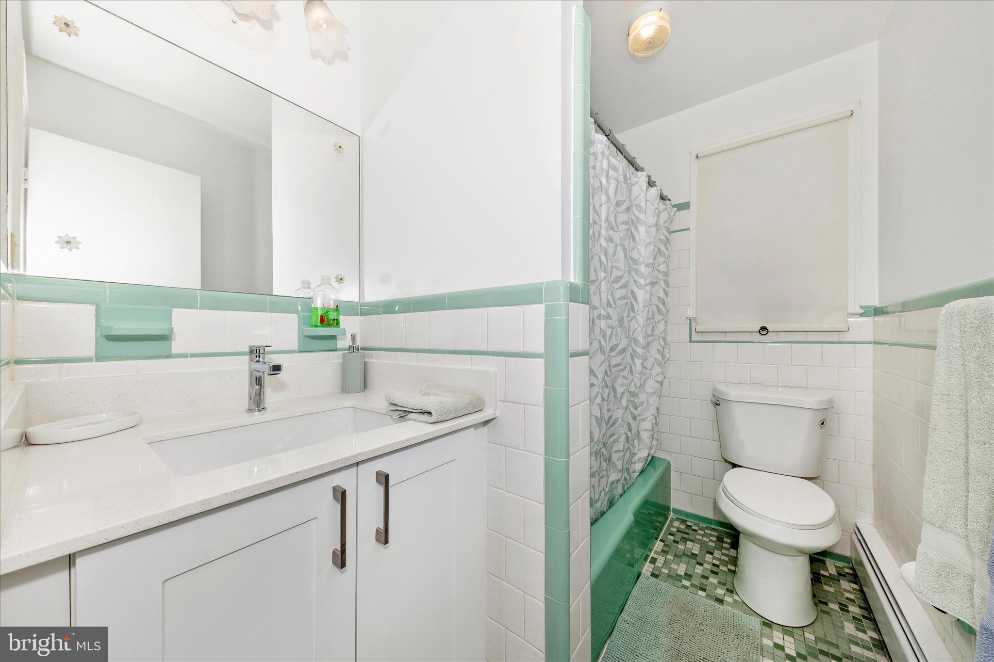 9811 Watkins Road Gaithersburg, MD 20882 - Photo 26 of 54 a bathroom with a sink a toilet and shower