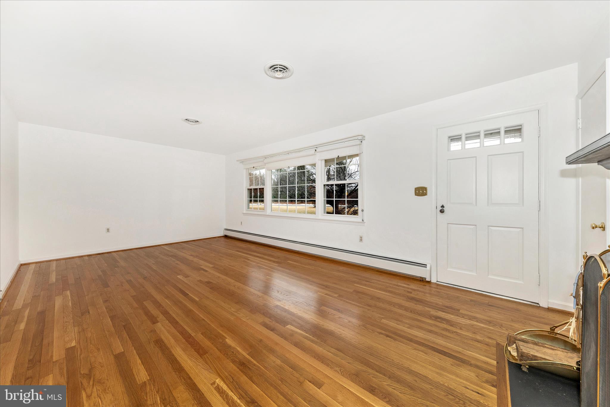 9811 Watkins Road Gaithersburg, MD 20882 - Photo 3 of 54 an empty room with wooden floor and windows