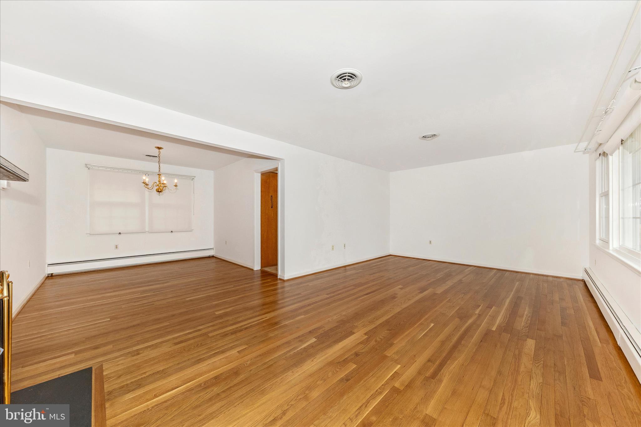 9811 Watkins Road Gaithersburg, MD 20882 - Photo 4 of 54 an empty room with wooden floor and windows