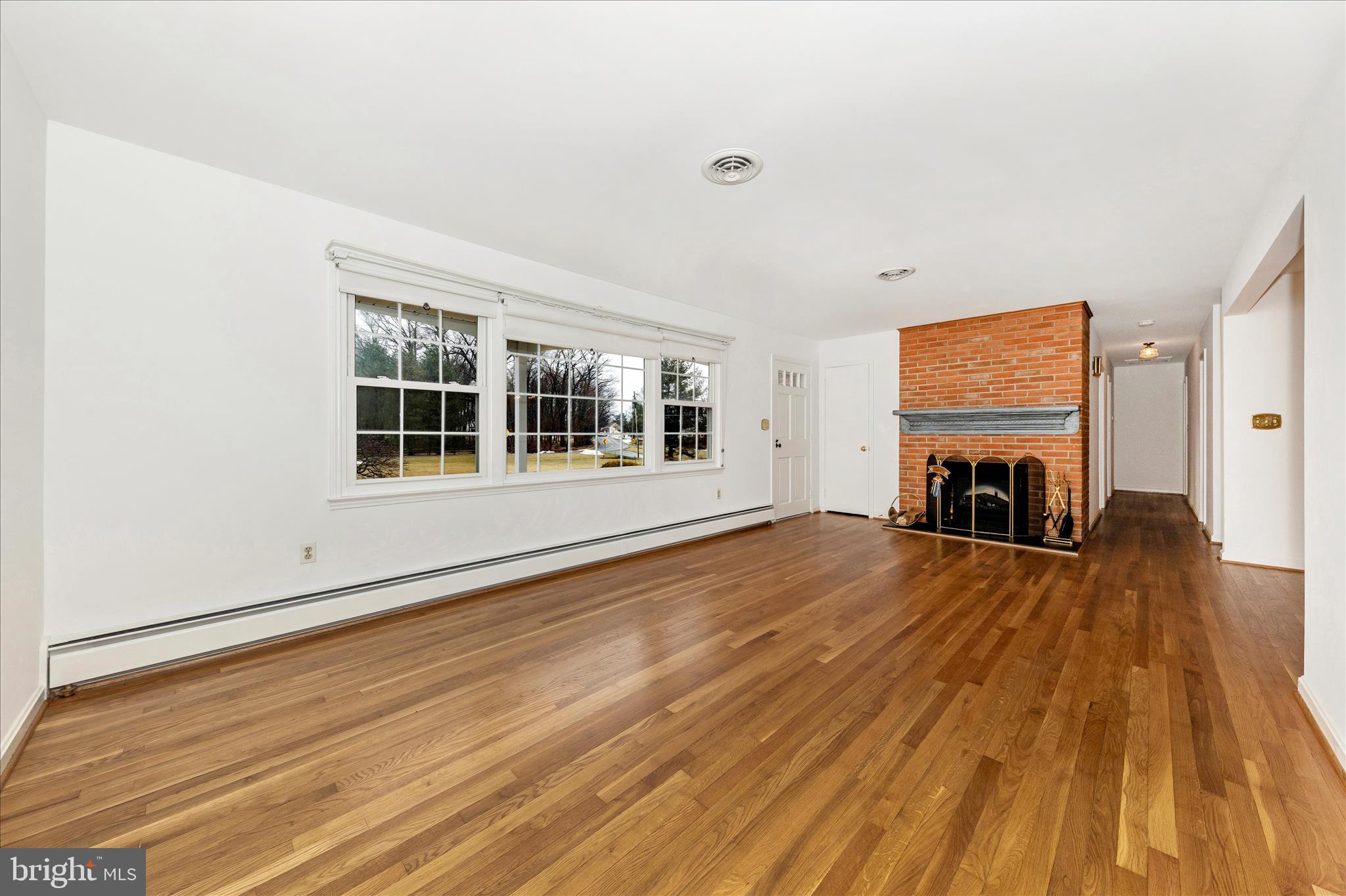 9811 Watkins Road Gaithersburg, MD 20882 - Photo 6 of 54 a view of a livingroom with wooden floor and a window