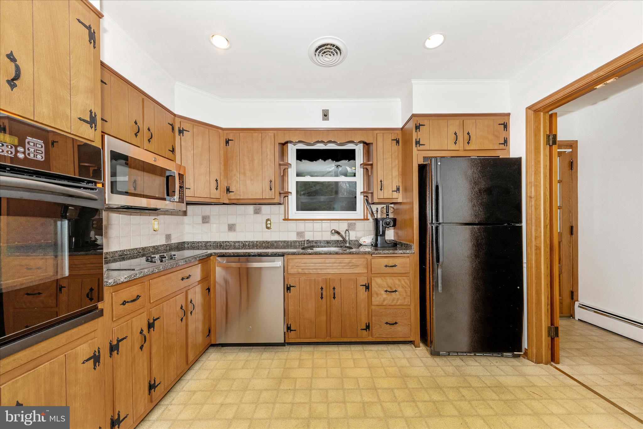 9811 Watkins Road Gaithersburg, MD 20882 - Photo 9 of 54 a kitchen with stainless steel appliances granite countertop a refrigerator and a stove top oven