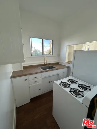 a kitchen that has a sink and a stove