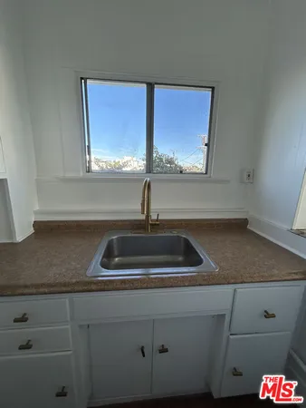 a kitchen with sink and window