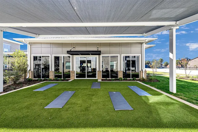 a view of a big yard with floor to ceiling windows
