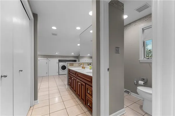 a bathroom with a sink a toilet and a mirror