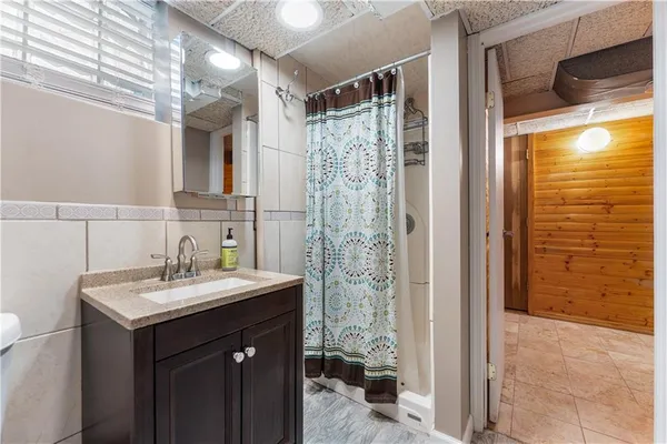 a bathroom with a sink a mirror and a shower