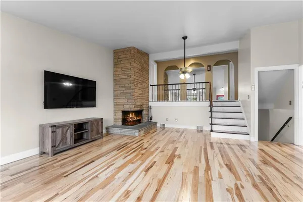 a view of a livingroom with wooden floor and a flat screen tv