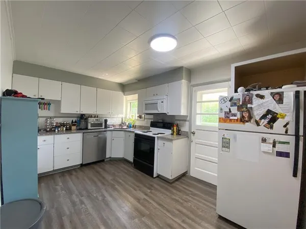 a kitchen with sink cabinets and wooden floor
