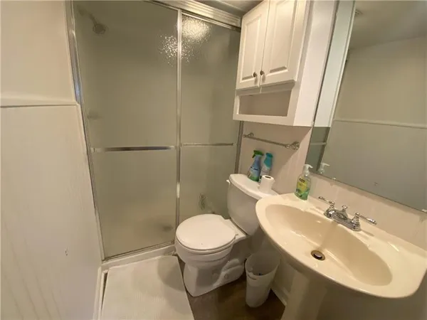 a bathroom with a sink toilet and shower