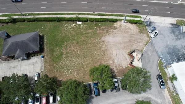 an aerial view of a house with a yard and lake view